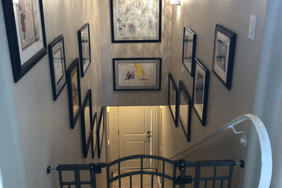 In the end, the staircase that leads down to our backyard and garage is now lined with much of collectible animation art